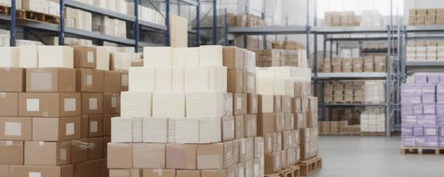 Stacked paper napkin cartons on pallets in a clean Canadian warehouse